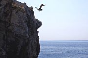 man jumping from a cliff on kornati and telascica boat tour