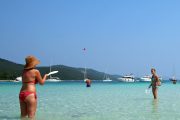 two ladies in the shallow sea during a boat tour