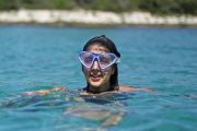 Girl snorkelling with a mask in Kornati islands bays
