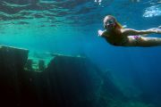 girl snorkeling around the sunken ship during a boat trip
