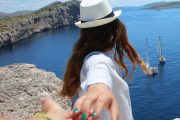 Girl with a hat looking cliffs and sea in Kornati