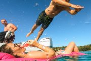 guy jumping from a boat and a girl on a floatie on silba and olib boat tour