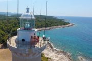 girls on top of lighthouse eith panoramic view aerial photo drone