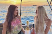 two ladies on a boat with the sunset in the background