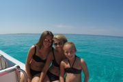two girls and kid on sakarun bay on a boat