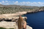 firl on a cliff looking panoramic vista on Kornati islands