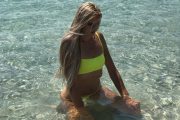 girl in yellow bikini in shallow sea in sandy lagoon on sakarun bay