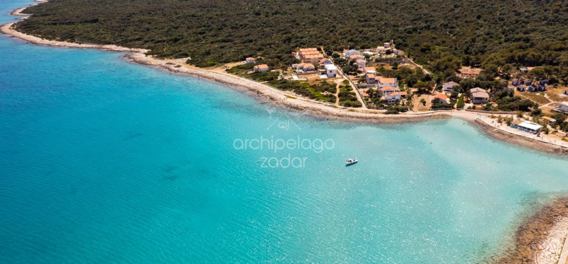 guy jumping from boat and a girl on a floatie on Zadar archipelago boat trip