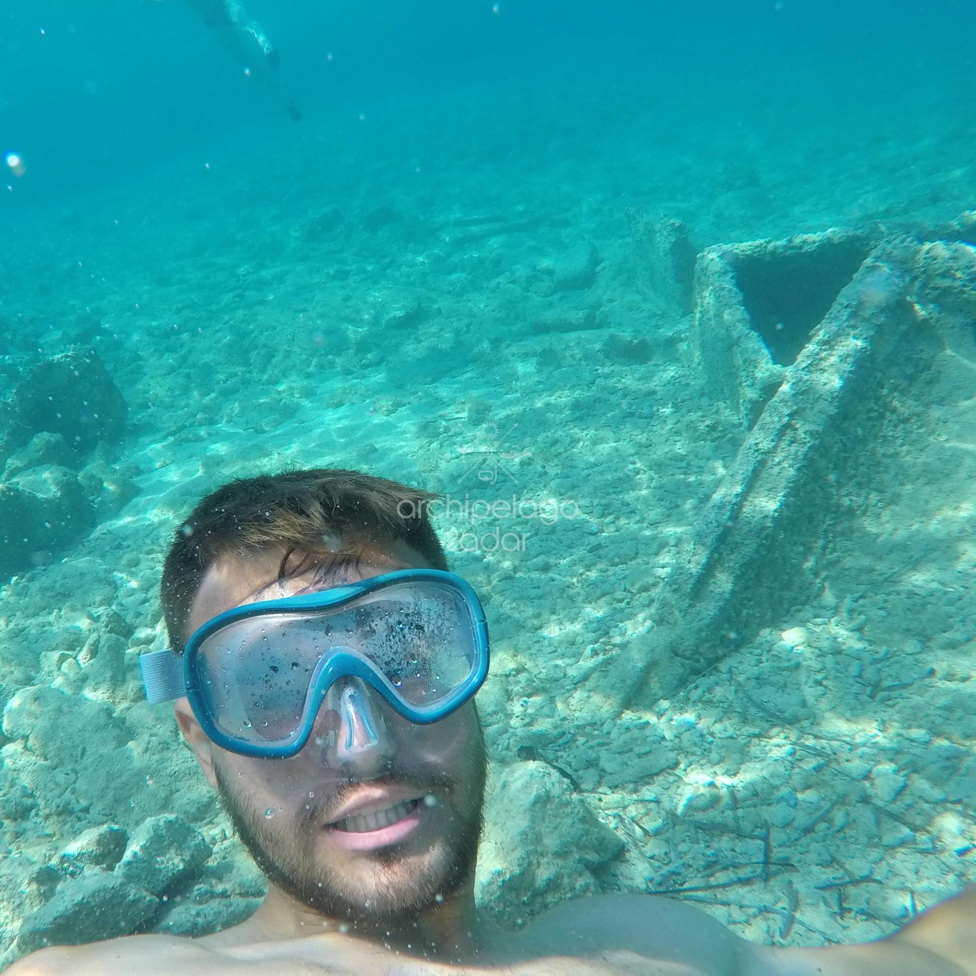 guy snorkeling with sunken sarchopagi on silba island