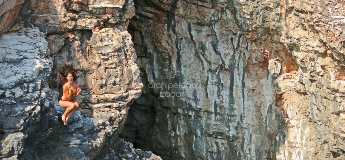 Cliff jumping girl on kornati