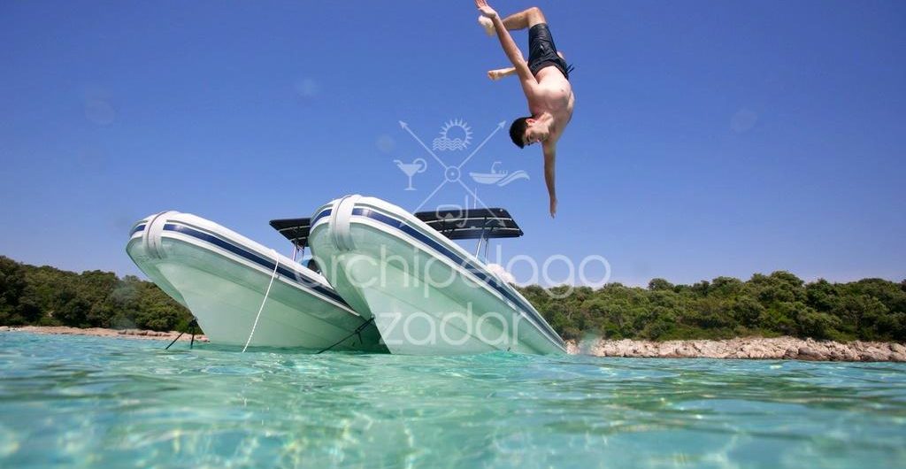 active boat tour guy jumping from a boat